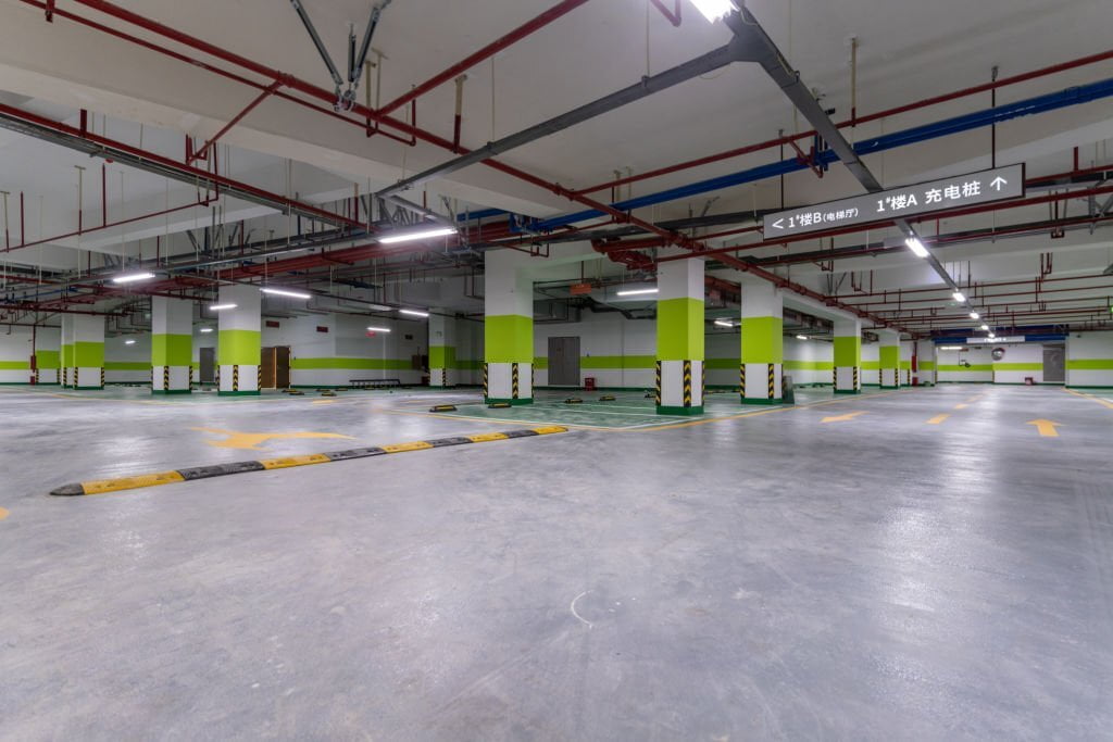 Empty and unfinished underground parking lot - concrete flooring in Michigan