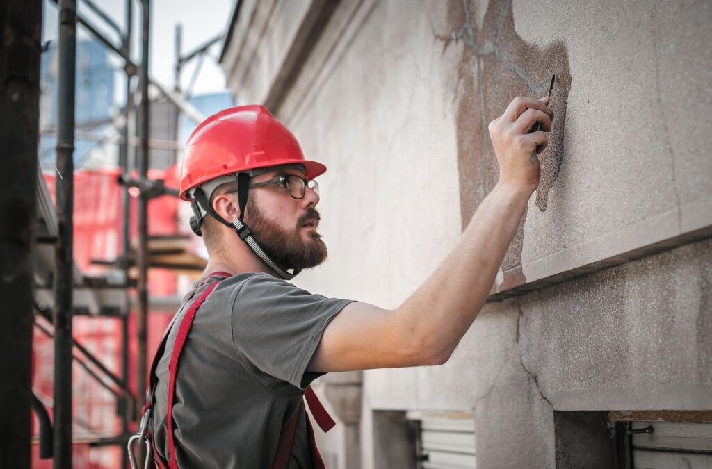 cement and concrete contractor analysing cement wall